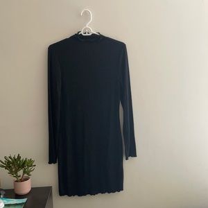 Black turtle neck dress with truffle details